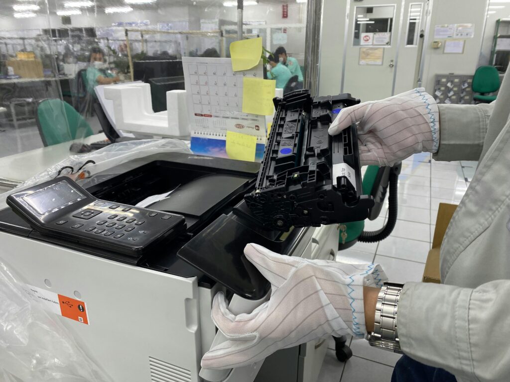 Man Changing Cartridge in a Printer