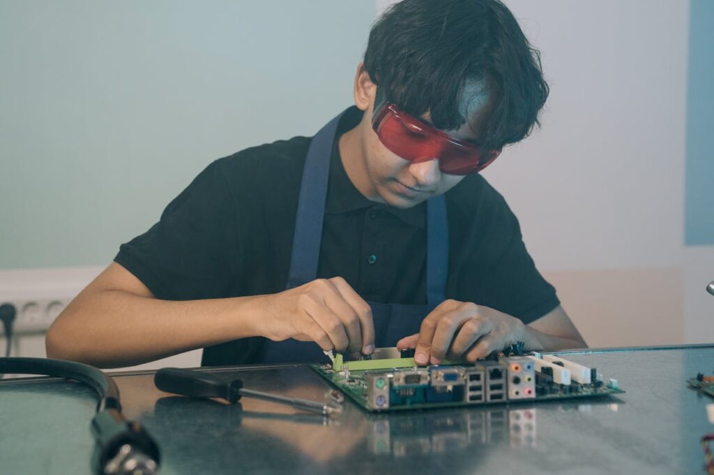 A Man Working on a Motherboard