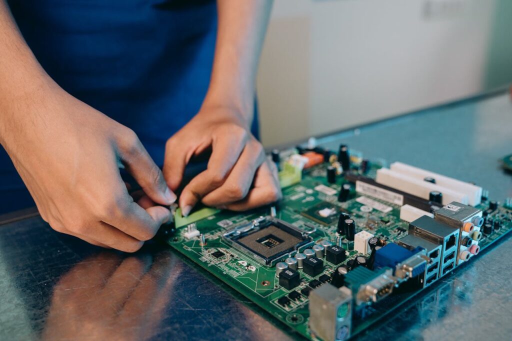 Close-up Photo of Person working on a Motherboard